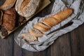 Bread. Assortment of different types of bread. Sliced Ã¢â¬â¹Ã¢â¬â¹bread on a wooden background. Loaf, bun, baguette, cereal bread.